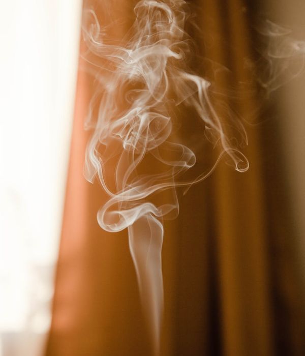 Person practicing a gentle, flowing movement in a minimalist room with soft light.